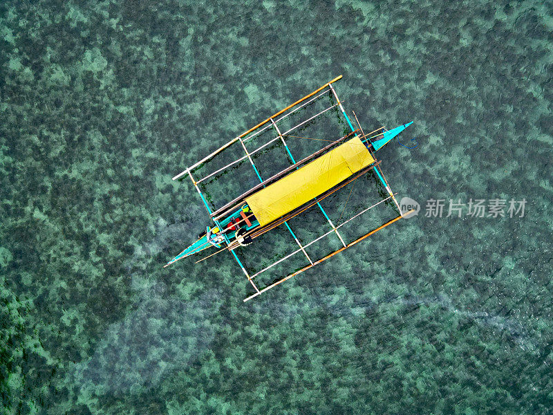 Top view of a boat in azure waters of the mid-ocean